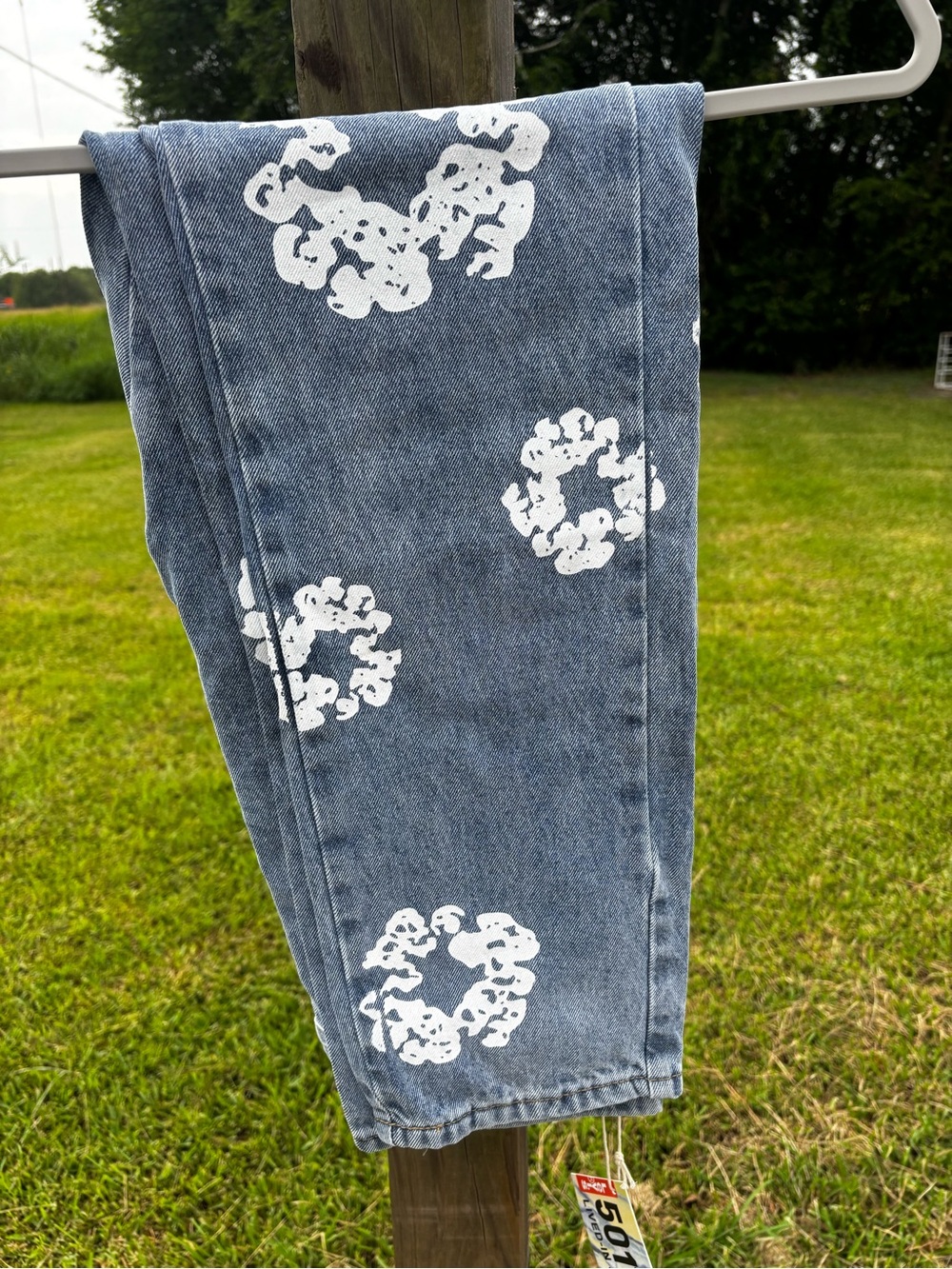 Blue Levi’s Denim Tears Jeans with White Floral Ring Prints
